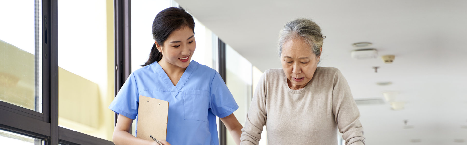 caregiver walking senior woman