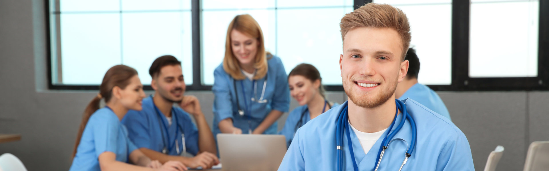 group of nurses on table with lead male nurse