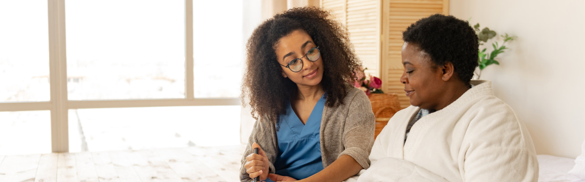 patient woman fed by caregiving nurse