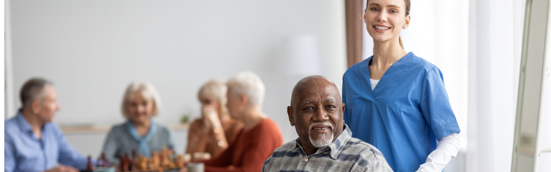 patient man sitting on wheelchair with his nurse